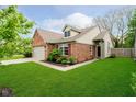 Attractive brick house with a manicured lawn, attached garage, and inviting front entrance at 11108 Oakridge Dr, Fishers, IN 46038