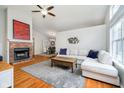 Spacious living room with hardwood floors, a brick fireplace, and a comfortable sectional sofa at 11108 Oakridge Dr, Fishers, IN 46038