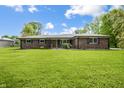 Inviting single-story brick home with a lush green lawn and traditional design at 1171 S Daisy Ln, New Palestine, IN 46163