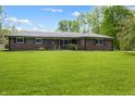 A single-story brick home with a well-manicured lawn and traditional architectural details at 1171 S Daisy Ln, New Palestine, IN 46163