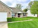Inviting home with lush green lawn, brick facade, and charming front porch at 11821 Bills Ave, Fishers, IN 46037