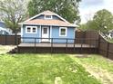 A cozy cottage featuring a wooden deck and fenced yard, perfect for outdoor relaxation at 125 Howard St, Greenfield, IN 46140