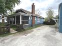 A charming home with a covered front porch and a gravel driveway at 125 Howard St, Greenfield, IN 46140