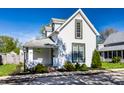 Charming two-story home featuring white siding, well-manicured lawn, and an inviting front porch at 139 N East St, Pendleton, IN 46064