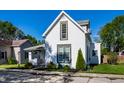 Charming two-story home featuring white siding, well-manicured lawn, and an inviting front garden at 139 N East St, Pendleton, IN 46064