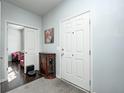 Inviting entryway featuring a coat closet and adjacent sitting room at 14584 Hinton Dr, Fishers, IN 46037