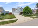 Attractive two-story home boasts a two-car garage, a spacious driveway, and a lush green lawn at 14584 Hinton Dr, Fishers, IN 46037