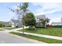 Lovely two-story home with a well-maintained lawn, mature trees, and a two-car garage at 14584 Hinton Dr, Fishers, IN 46037