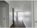 Bright hallway showcasing hardwood floors, neutral paint, and an open view of the living space at 14584 Hinton Dr, Fishers, IN 46037