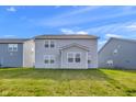 View of the home's backyard showcasing a well-maintained lawn at 17344 Hanningfield Way, Westfield, IN 46074