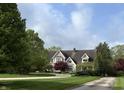 Traditional style home with manicured lawn, mature trees, and inviting curb appeal at 2090 Mulsanne Dr, Zionsville, IN 46077