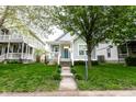 Charming single Gathering home with a welcoming curb appeal, a covered front porch and mature shade trees at 2237 N New Jersey St, Indianapolis, IN 46205