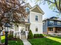 Beautiful two-story home with lush green lawn and a welcoming entrance, complete with mature trees at 2251 N New Jersey St, Indianapolis, IN 46205