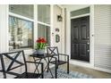 Inviting front porch with cozy seating and decorative tulips, perfect for enjoying the outdoors at 2251 N New Jersey St, Indianapolis, IN 46205