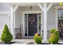 Inviting front entrance with a wreath, stylish decor, and manicured landscaping at 2396 Creek Bank Dr, Columbus, IN 47201