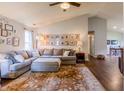 Bright living room featuring a comfortable sectional sofa, a decorative rug, and a gallery wall of Gathering photos at 2449 Orchard Creek Dr, Columbus, IN 47201