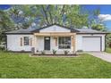 Charming single-story home featuring a freshly painted exterior, front porch, and attached garage at 2706 Shakespeare Dr, Indianapolis, IN 46227