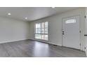 Bright living room featuring a large window and fresh paint, and modern gray flooring at 2706 Shakespeare Dr, Indianapolis, IN 46227