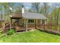 Charming home with a large deck, a satellite dish, and a walkway leading to the front door at 2985 Little Hurricane Rd, Martinsville, IN 46151