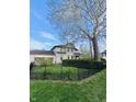 Exterior view of the house showcasing the well-maintained lawn and fence at 301 N Main St, Franklin, IN 46131
