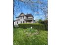 View of the home's exterior, with a manicured hedge and a glimpse of the yard at 301 N Main St, Franklin, IN 46131
