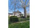 Exterior view of the house showcasing the well-maintained lawn and fence at 301 N Main St, Franklin, IN 46131