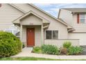 Inviting home featuring a covered entrance with well-maintained landscaping and a bright red front door at 3050 Wildcat Ln, Indianapolis, IN 46203