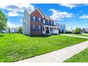 Beautiful two-story brick home with a covered porch, set back on a lush green lawn at 3101 Woodhaven Way, Bargersville, IN 46106