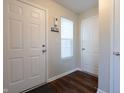 Inviting foyer featuring a stylish key rack, a window, and sleek wood-look flooring at 3367 Rolling Knoll Ln, Columbus, IN 47201