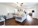 Comfortable living room with a large sectional sofa, ceiling fan, and open access to kitchen at 3367 Rolling Knoll Ln, Columbus, IN 47201