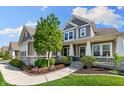 Charming two-story home featuring manicured landscaping and inviting front porch at 3561 Shady Lk Dr, Westfield, IN 46074