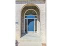 Inviting entryway featuring a stylish blue front door with sidelights and arched transom window at 3948 S Woodfield Dr, New Palestine, IN 46163