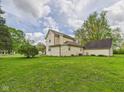 Large, well-maintained lawn and backyard with mature trees and access to detached garage at 4079 S 50 W, Anderson, IN 46013