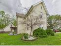 Charming exterior view showcasing a well-maintained lawn with garden beds and a charming porch at 4079 S 50 W, Anderson, IN 46013