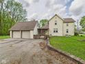 Home with a two-car garage and a welcoming stone entrance, featuring manicured landscaping at 4079 S 50 W, Anderson, IN 46013