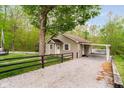 A charming home with a covered carport, gravel driveway and a black fence at 4091 W Briarwood Lake S Dr, Monrovia, IN 46157