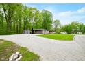 Brick home with a detached garage and a storage shed surrounded by a gravel driveway at 4291 E Lakeview Dr, Martinsville, IN 46151