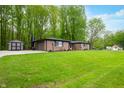 Spacious backyard featuring a brick home, green lawn, and additional storage shed at 4291 E Lakeview Dr, Martinsville, IN 46151