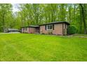 Home with a well-maintained lawn, a black chain-link fence, and a storage shed in the backyard at 4291 E Lakeview Dr, Martinsville, IN 46151