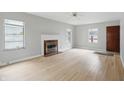 Bright living room with a fireplace, hardwood floors, and neutral paint, ready for your personal touch at 4730 Rookwood Ave, Indianapolis, IN 46208