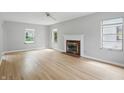 Spacious living room featuring hardwood floors, a fireplace, and bright natural light at 4730 Rookwood Ave, Indianapolis, IN 46208