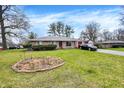 Well-maintained single-story brick home with a lovely lawn and a paved driveway at 5027 E 40Th St, Indianapolis, IN 46226