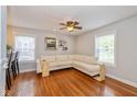 Bright living room with hardwood floors, large sectional sofa, and natural light from multiple windows at 5526 Indianola Ave, Indianapolis, IN 46220
