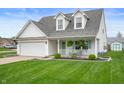 Inviting home with a well-kept lawn, two-car garage, and a welcoming front porch at 610 Redwood Dr, Pendleton, IN 46064