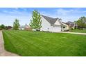 Large, well-maintained front yard showcasing lush green grass at 610 Redwood Dr, Pendleton, IN 46064