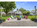 Backyard with brick patio and gravel fire pit area, perfect for relaxing outdoors at 6288 Buttonwood Dr, Noblesville, IN 46062