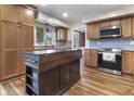 Stylish kitchen with stainless steel appliances, gray backsplash, and a wooden center island at 6288 Buttonwood Dr, Noblesville, IN 46062
