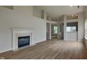 Spacious living room with hardwood floors, a cozy fireplace, and an open floor plan at 7018 Mallard Way, Plainfield, IN 46168