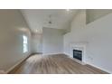 Inviting living room with fireplace, high ceilings, and natural light flowing through the front door at 7018 Mallard Way, Plainfield, IN 46168