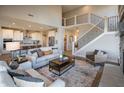 Spacious living room featuring an open floor plan, staircase, fireplace, and modern furniture at 7032 Portico Ln, McCordsville, IN 46055